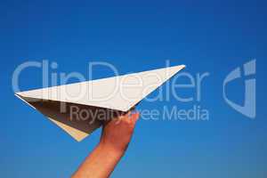 Hand holding paper plane