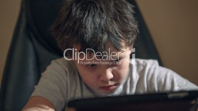 kid with tablet pc at the table