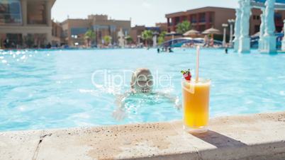 woman in the pool with juice