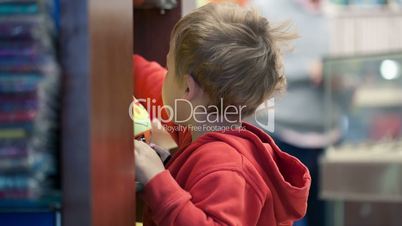 Cute little boy shopping for toys