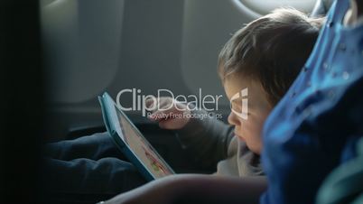 Little boy traveling in an airplane