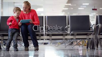 Young mother and son in an airport terminal