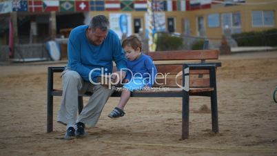 grandfather and grandson on the bench