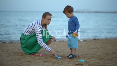 Mother and son playing on the beach