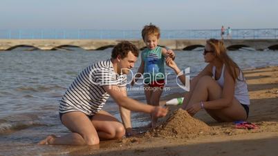 Family making a sandcastle