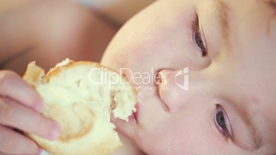 Close-up of a child eating a bun