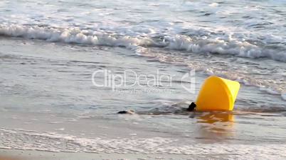 Yellow buoy in the waves
