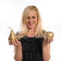 attractive woman holding a golden pear and apple