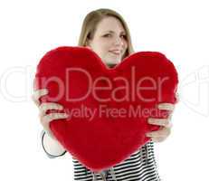 young woman smiling with heart shaped pillow