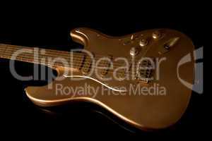 gold electric guitar on a dark background