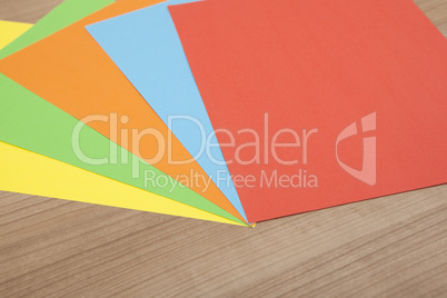 colored paper on wooden background