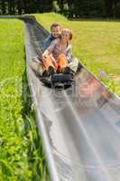 happy couple enjoying alpine coaster luge