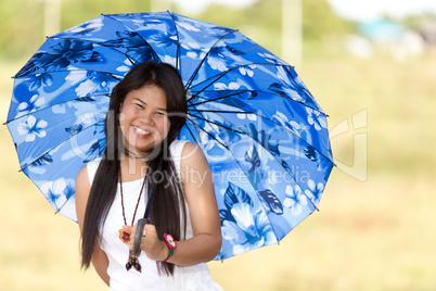 beautiful young thai girl under a blue sunshade