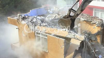 Digger using its bucket to demolish house. Time Lapse