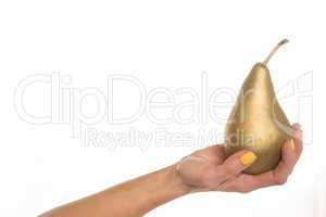 female hand holding a golden pear, on white