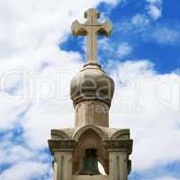 stone cross on blue sky background