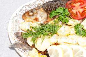 Fresh crucian river fish fried in lemon juice and fresh herbs
