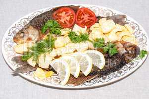 Fresh crucian river fish fried in lemon juice and fresh herbs
