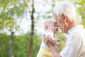 asian grandfather kissing grandson