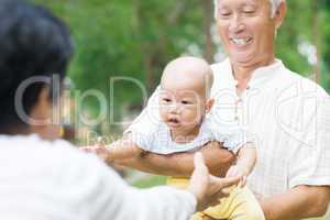 asian grandparents playing with grandchild