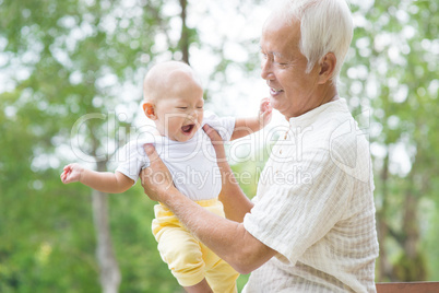 asian grandfather playing with grandson