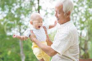asian grandfather playing with grandson