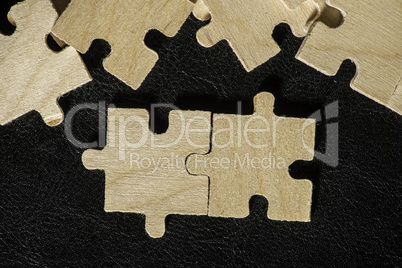 Wooden puzzle on black background