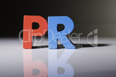 Multicolored word PR made of wood.