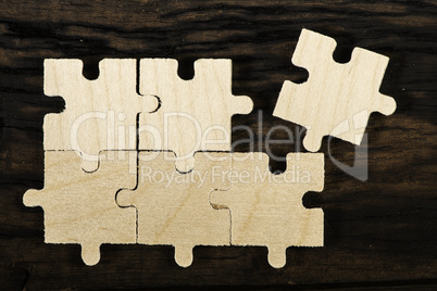 Wooden puzzle on dark background.