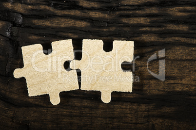 Wooden puzzle on dark background.