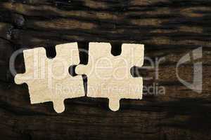 Wooden puzzle on dark background.