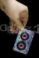 Hand holding vintage cassette tape