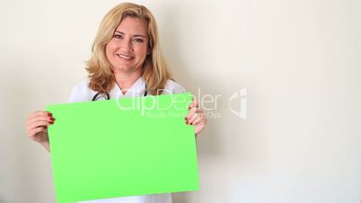 female doctor holding onto a green screen