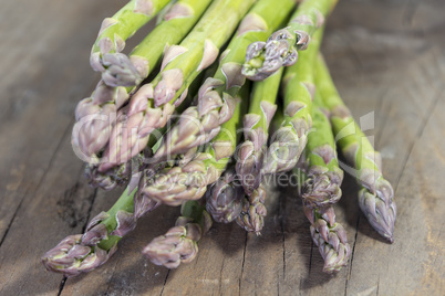green asparagus on wood