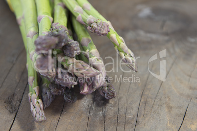 green asparagus on wood