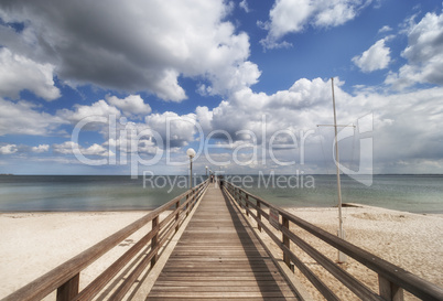 wooden pier over the baltic sea with clouds
