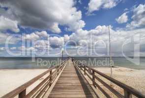 wooden pier over the baltic sea with clouds