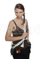 young craftswoman with a tool belt in front of white background