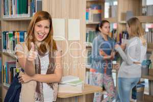 student showing thumb up in library