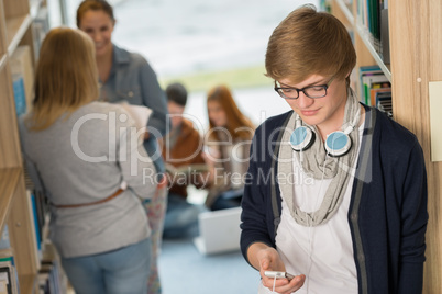 student with headphones in college library