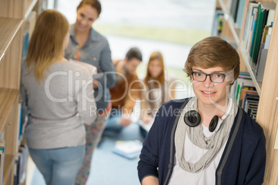 student with headphones in library