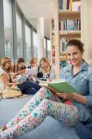 student sitting in school library with friends