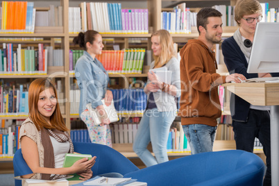 smiling student in library with friends