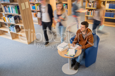 student writing notes in library blur motion