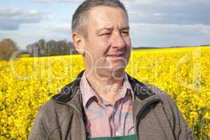 farmer stands in rape field