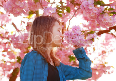 young girl smelling blossoms