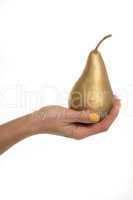 Female hand holding a gold pear
