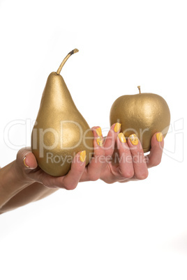 Woman holding a golden fresh pear and apple