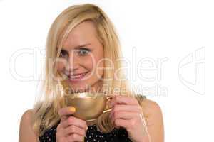 Beautiful woman drinking from a golden cup