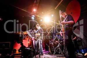 Band performs on stage in a nightclub